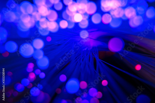 blurred abstract vibrant neon background with shiny bokeh