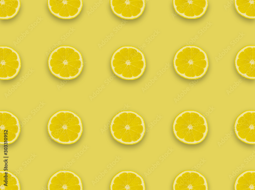 Pattern.Fresh lemon slices on a yellow background.Flat lay, top view - image background.