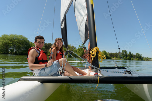 young couple in love on sail boat