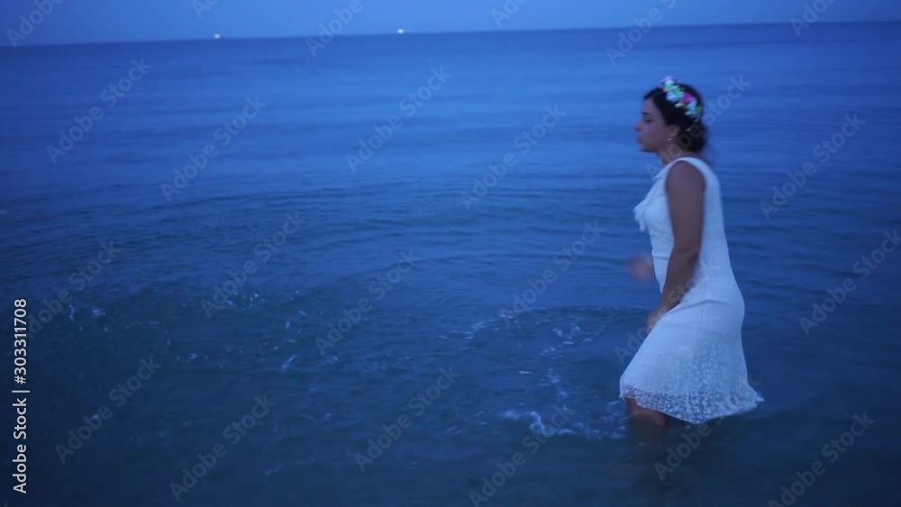 Beautiful girl walking on the beach. A young girl in a dress bathing in the sea. Beautiful girl in white dress on the beach. Beautiful girl walking on the beach. A young girl in a dress bathing in the sea. Beautiful girl in white dress on the beach.