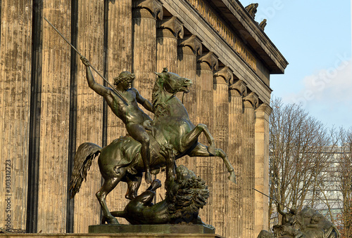 The 1859 lion fighter statue outisde the Altes Museum (Old Museum) in Berlin, Germany photo