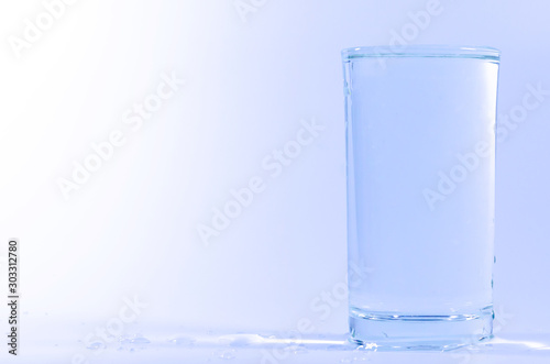 Blue, spread in water inside the glass, isolated on a white background