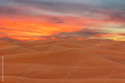 Sand desert dunes sunset landscape view, picturesque landscape with sun, UAE.