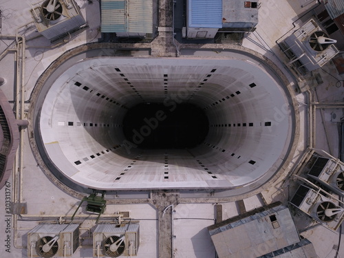 Kuching, Sarawak / Malaysia - November 15 2019: Creative shot - an aerial top down view of a donut shaped building in Kuching, the island of Borneo. The core of the building was empty. photo