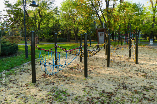 Fototapeta Naklejka Na Ścianę i Meble -  Autumn in the city park of Burgas, Bulgaria. Children rope playground in the park