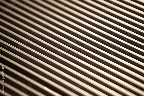Close-up of a corrugated metal surface of an unidentified factory equipment. The concept of sophisticated equipment and modern technology. Kitchen appliance production concept