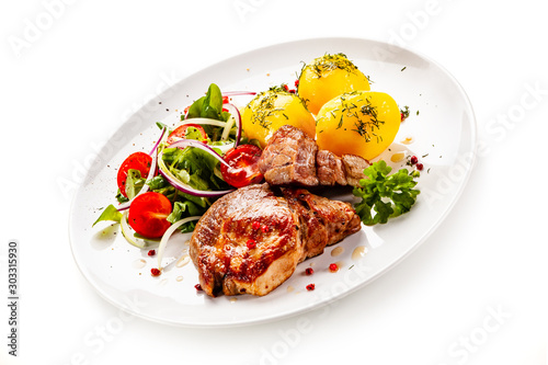 Grilled steak with boiled potatoes and vegetable salad