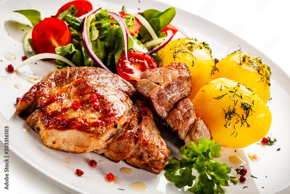 Grilled steak with boiled potatoes and vegetable salad Grilled steak with boiled potatoes and vegetable salad