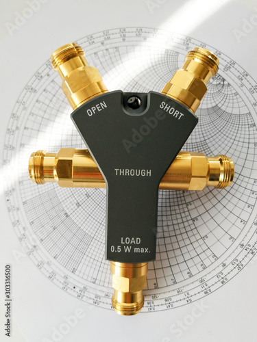 Calibration kit for RF VNA in front of Smith chart photo