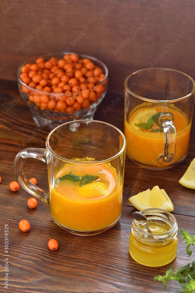 Sea buckthorn tea with lemon, honey and mint, vertical Sea buckthorn tea with lemon, honey and mint, vertical