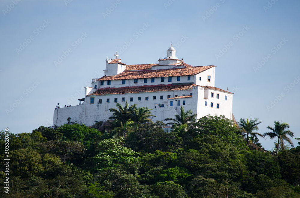 Obraz premium Penha Convent, a convent in Vila Velha, Brazil, on the top of a high mountain overlooking the cities of Vitória and Vila Velha