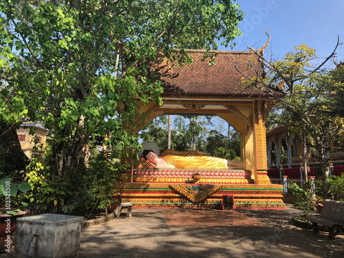 Khmer-style statue of reclining Buddha in a garden, Tra Vinh, Vietnam