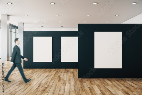 Businessman in gallery with poster