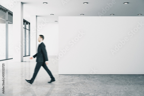 Businessperson in gallery with poster