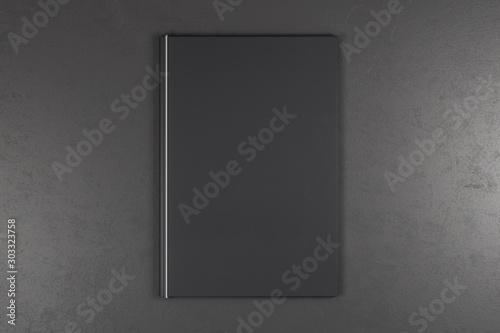Empty black book on grey background