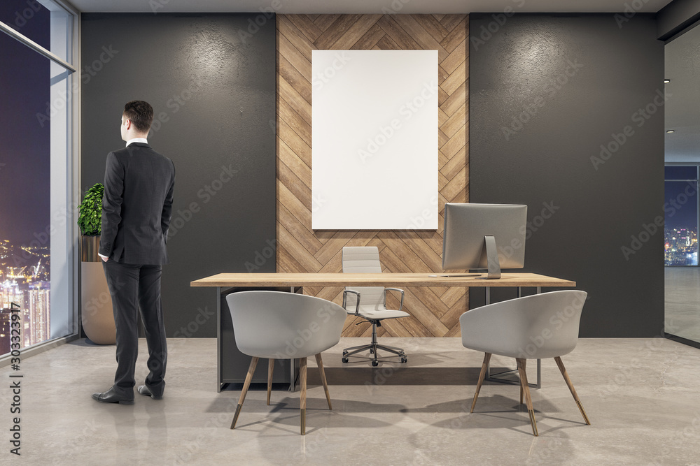 Businessman in modern office interior with billboard - obrazy, fototapety, plakaty 