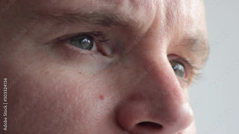 Hopeful redhead bearded man with blue eyes staring, extreme close up tilt Hopeful redhead bearded man with blue eyes staring, extreme close up tilt