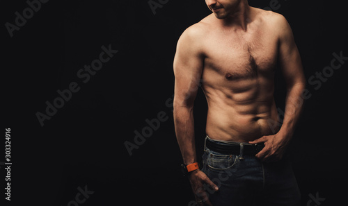 Natural athletic body of sportsman standing in studio