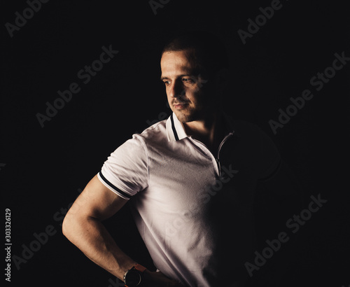 Man looking away in white t-shirt in studio