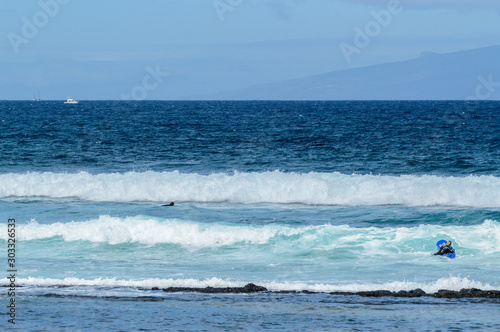 Surfer Waiting For Waves At Sunset On Las Americas Beach. April 11, 2019. Santa Cruz De Tenerife Spain Africa. Travel Tourism Street Photography.