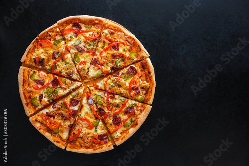 tasty homemade sliced pizza on black background top view copy space