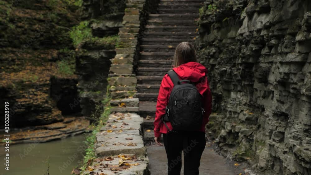 Female tourist walking through Watkins Glen State Park natural gorge Female tourist walking through Watkins Glen State Park natural gorge