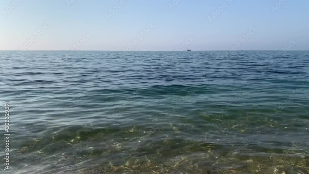 Beautiful long slender female legs are washed by the waves of the sea. Black Sea, Crimea, Sevastopol. Beautiful long slender female legs are washed by the waves of the sea. Black Sea, Crimea, Sevastopol.