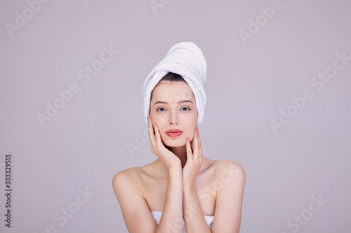 Image of an adorable half-naked woman wrapped in a towel.