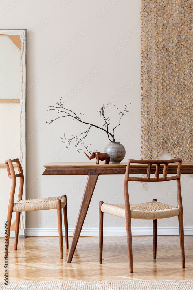 Φωτογραφία Stylish and beige interior of dining room with design wooden table and chairs, vase with flowers, sculpture, elegant and rattan accessories