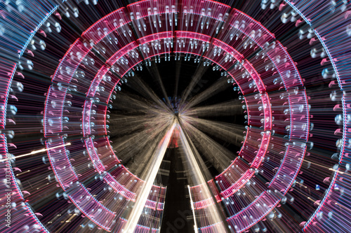 Long exposure zoom of a ferris wheel at night