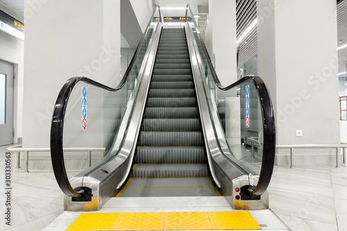 modern people-free escalator with tiles for the blind at the airport photo
