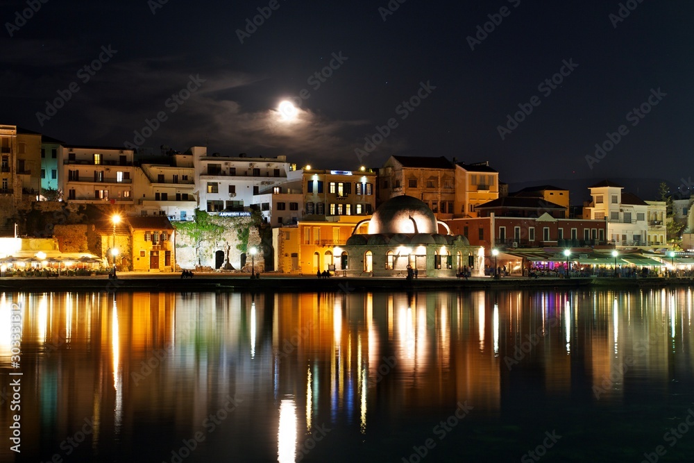 Chania town skyline at night with full moon, Crete, Greece