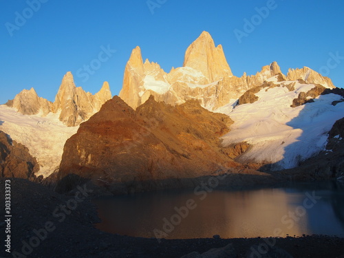 A woman hiker watching the beautiful sunrise, Precious scenery created by nature, Mount Fitz Roy, Los Glaciares National Park near El Chalten, Patagonia, Argentina