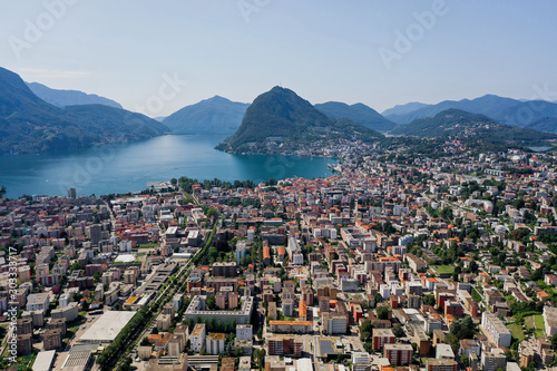 Fototapeta Naklejka Na Ścianę i Meble -  Aerial drone shot of monte salvatore, lugano city and lake in sunny day