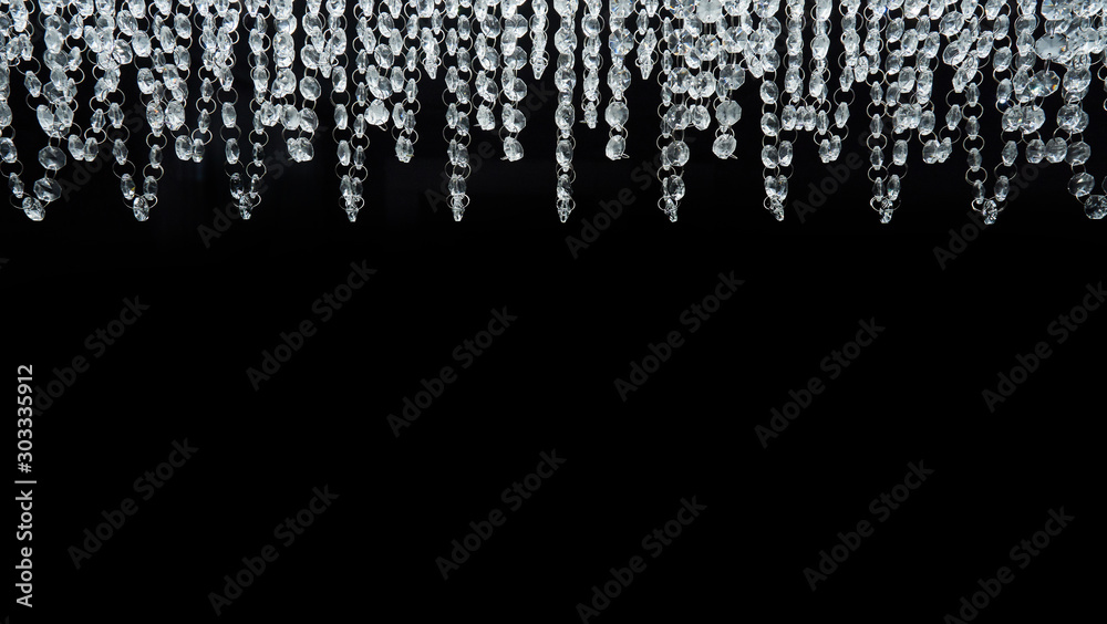Chandelier with glass beads on a black background, close-up Chandelier with glass beads on a black background, close-up