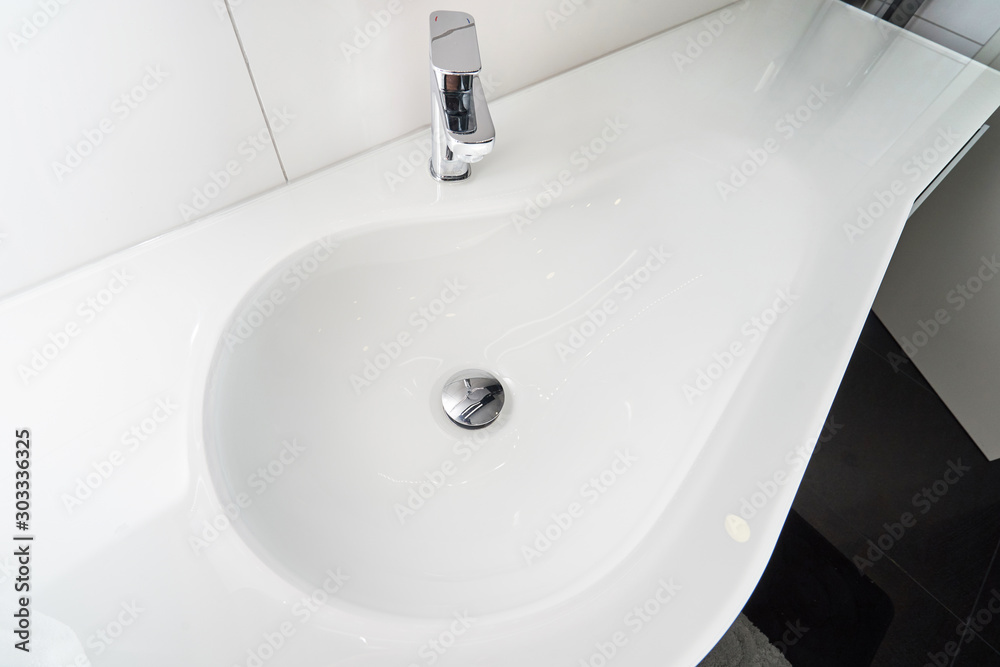 Beautiful chrome tap and new white drop-shaped sink Beautiful chrome tap and new white drop-shaped sink