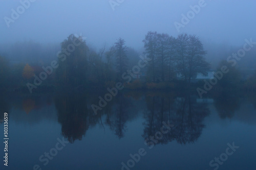 Lake in the autumn foggy morning
