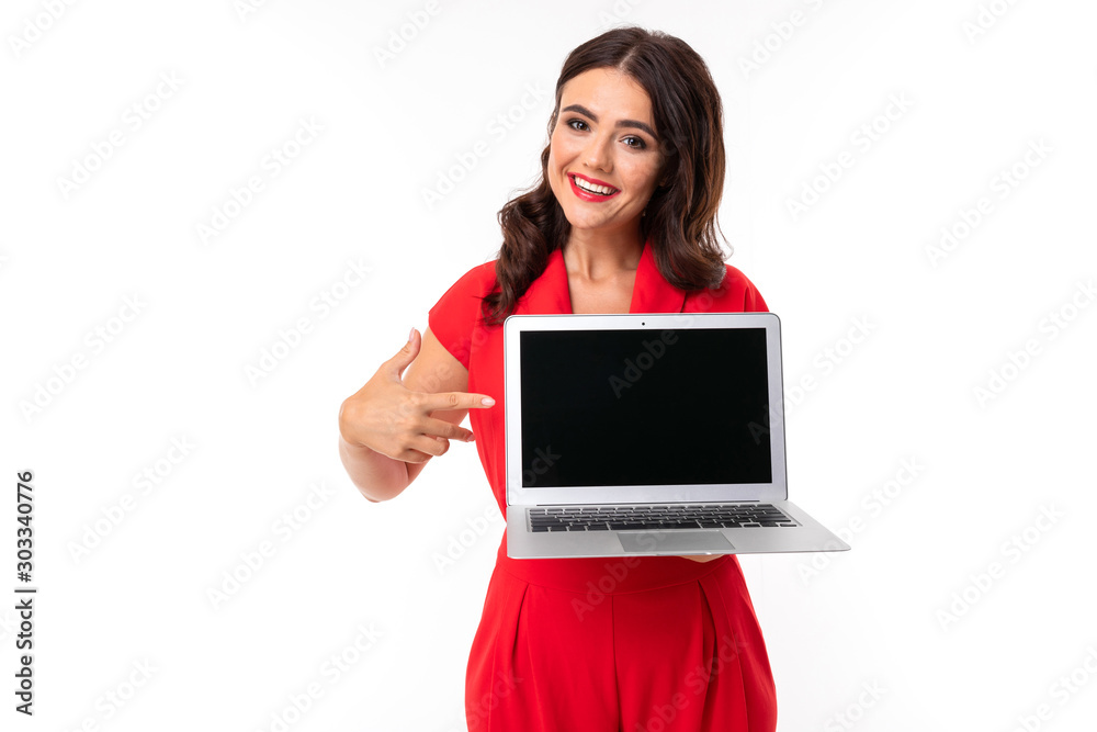 A young woman with red lips, bright makeup, works with a white laptop and shows something on screen, picture isolated on white background A young woman with red lips, bright makeup, works with a white laptop and shows something on screen, picture isolated on white background