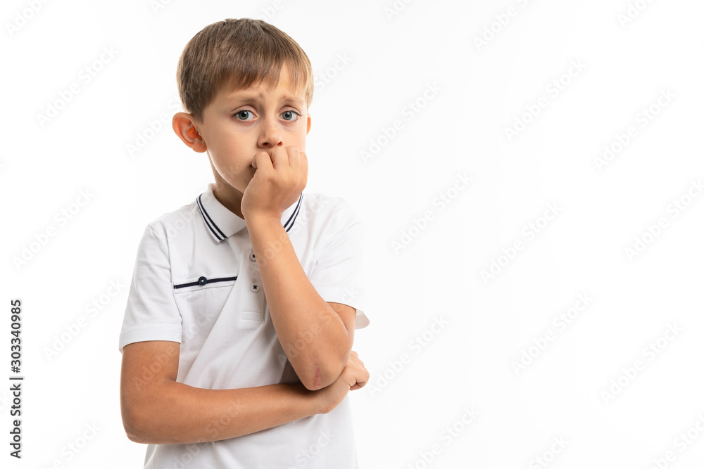 A little blonde boy thinks about something serious, picture isolated on white background A little blonde boy thinks about something serious, picture isolated on white background