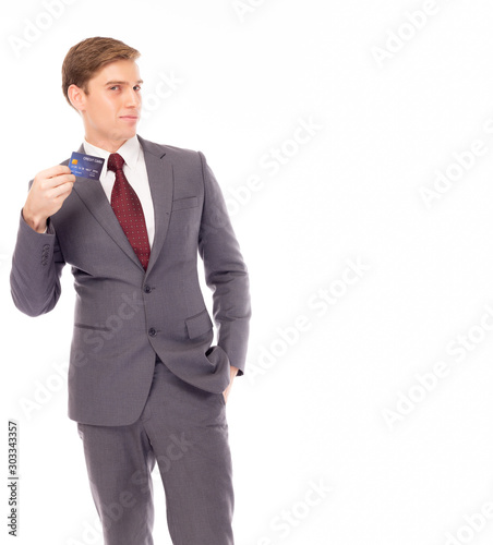 Portrait handsome young businessman holding credit card. Executive guy wear suit, necktie or formalwear. English young man looks smart, confident and rich. copy space, isolated on white background