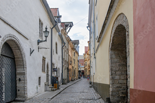 Medieval narrow street of Tallinn Old Town with cobblestone pavement