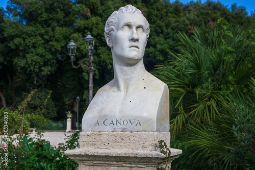 Old marble bust of Antonio Canova in the public park Pincian Hill, Villa Borghese gardens, Rome, Italy photo