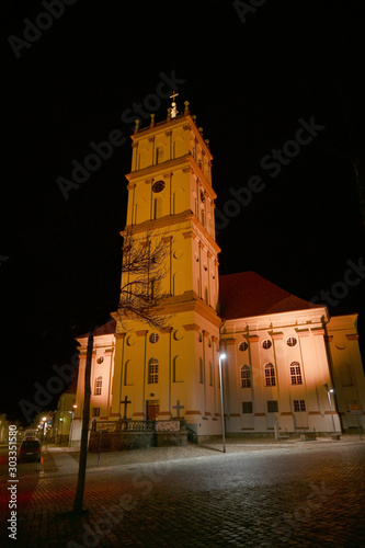 City Church of Neustrelitz illuminated at night on the market place, cityscape with copy space in the black sky, Mecklenburg-Vorpommern, Germany