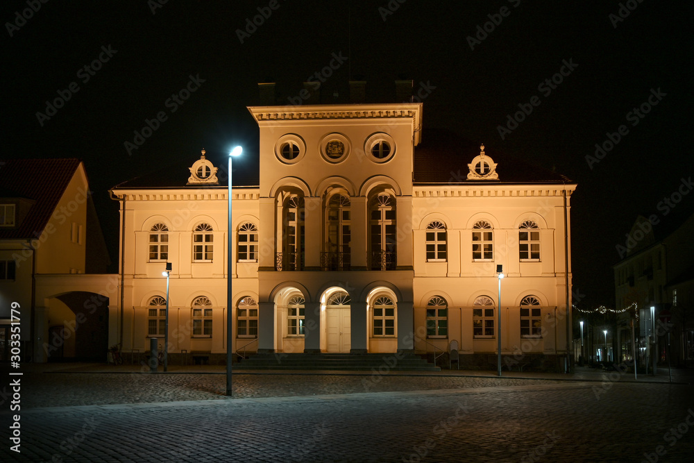 Neustrelitz town hall illuminated at night on the market place in the centre of the city, black sky, Mecklenburg-Vorpommern, Germany