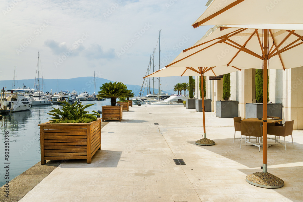 Cozy and beautiful street cafe on the sea promenade in Tivat, Montenegro.