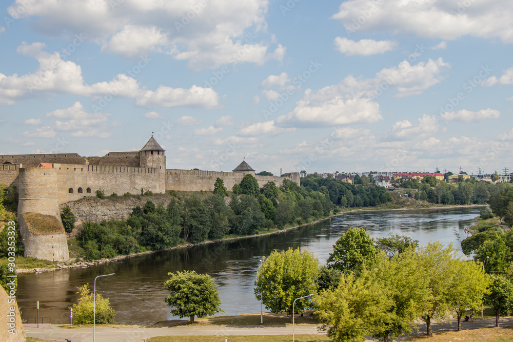 View of fortress wall of Russian Ivangorod fortress and border river Narva from Estonian coast.