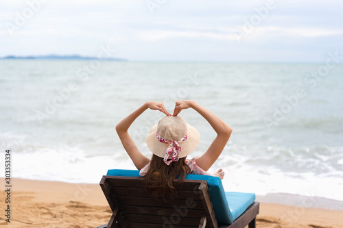 Woman arm up with heart sign. photo