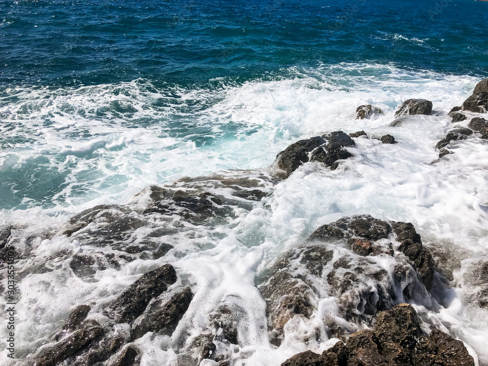 Seascape. Background with rocks and waves with foam. Mediterranean Sea. Seascape. Background with rocks and waves with foam. Mediterranean Sea.