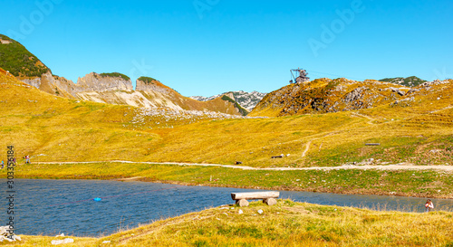 Landscape, autumn, Austria - A beautiful seat on a bench on the Loser Alm, on the circular walk Augstsee, in Styria, on a sunny cloudless day in October. photo