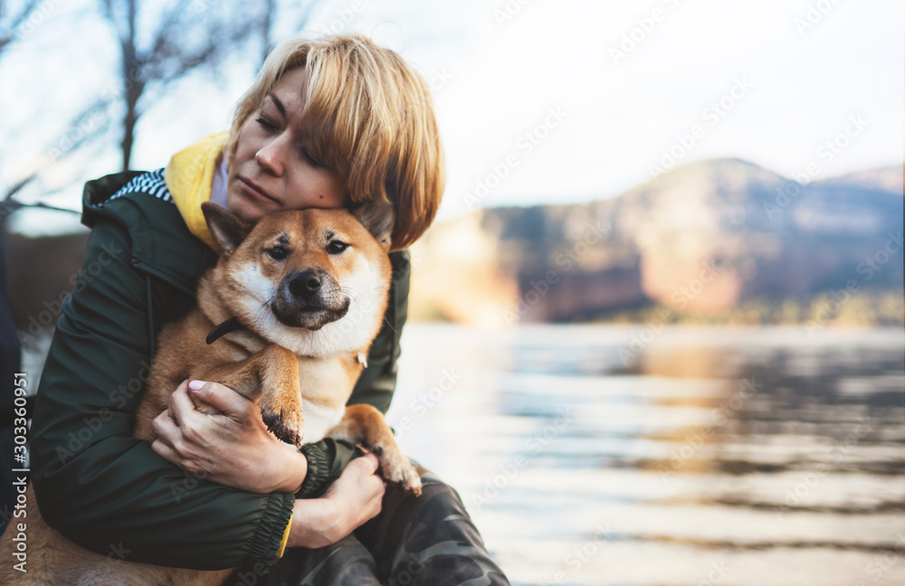 tourist traveler girl together dog background mountain lake, happy woman hug puppy pet nature, friendship love concept - obrazy, fototapety, plakaty 